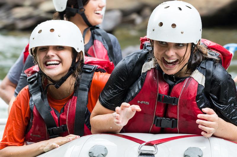 two girls laughing while rafting the Ocoee
