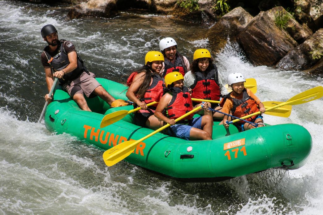 5 guests in a whitewater raft on the Nantahala river